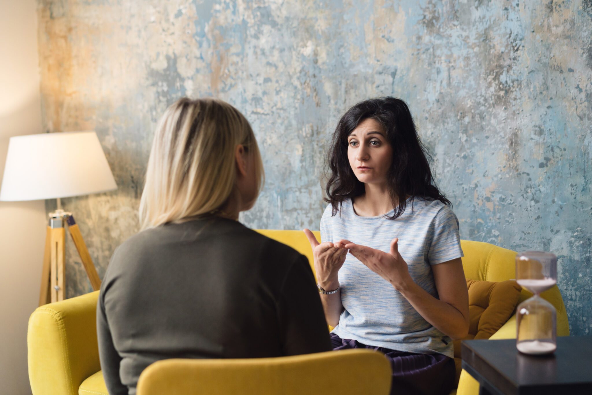 Woman psychologist talking to patient woman.